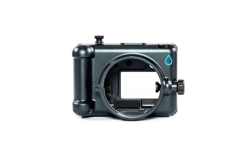 A sleek black underwater camera housing designed for Fujifilm cameras is displayed on a white background, featuring a large lens port opening, control dials, and Salty Surf Housings logo on the top right corner.