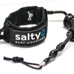 Black surf bicep leash by Salty Surf Housings featuring a padded neoprene armband and a coiled urethane cord.