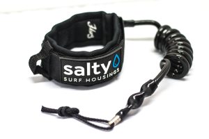 Black surf bicep leash by Salty Surf Housings featuring a padded neoprene armband and a coiled urethane cord.